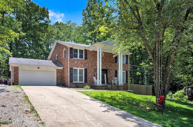 404 Bellemeade St, Brandenburg, KY 40108 - neoclassical home with a garage, driveway, brick siding, and a front yard