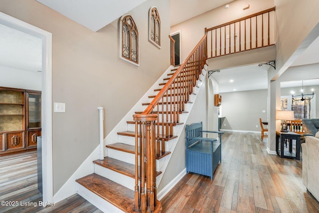 404 Bellemeade St, Brandenburg, KY 40108 - stairway featuring wood finished floors, baseboards, and a towering ceiling