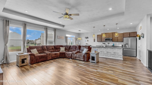 125 Bridlewood Dr, Shepherdsville, KY 40165 - living room with a tray ceiling, light wood finished floors, ceiling fan, and recessed lighting