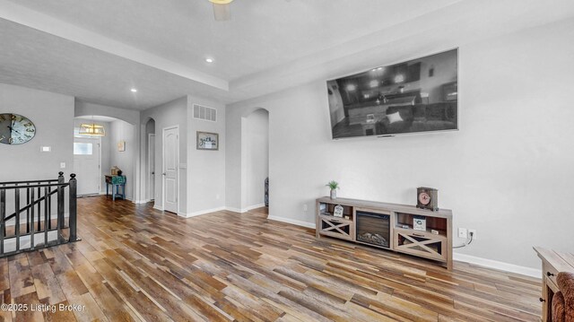 125 Bridlewood Dr, Shepherdsville, KY 40165 - living area featuring arched walkways, wood finished floors, and recessed lighting