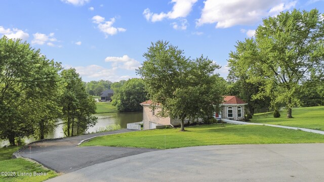 3205 Lake Pointe Ct, Crestwood, KY 40014 - view of front of property featuring a water view, driveway, a front lawn, and a garage