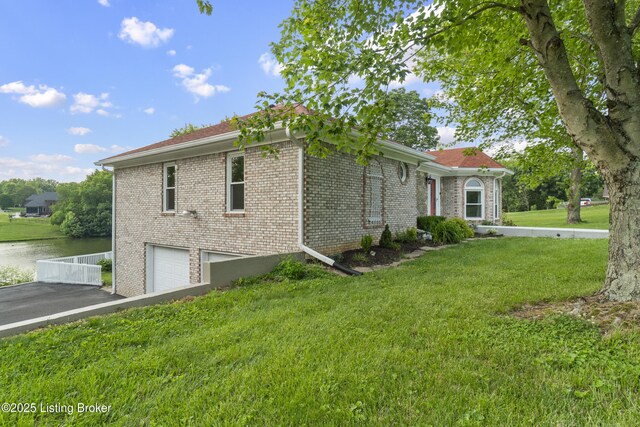 3205 Lake Pointe Ct, Crestwood, KY 40014 - view of side of property with a garage, brick siding, asphalt driveway, a water view, and a lawn