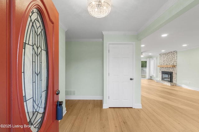 3205 Lake Pointe Ct, Crestwood, KY 40014 - foyer featuring light wood-style floors, a chandelier, baseboards, crown molding, and a fireplace