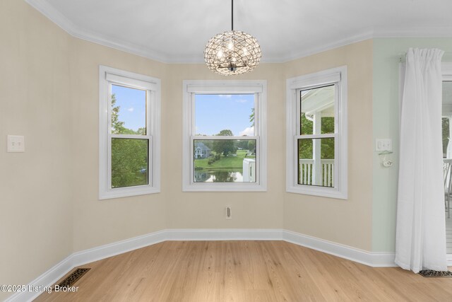 3205 Lake Pointe Ct, Crestwood, KY 40014 - unfurnished dining area featuring a chandelier, light wood finished floors, plenty of natural light, baseboards, and crown molding