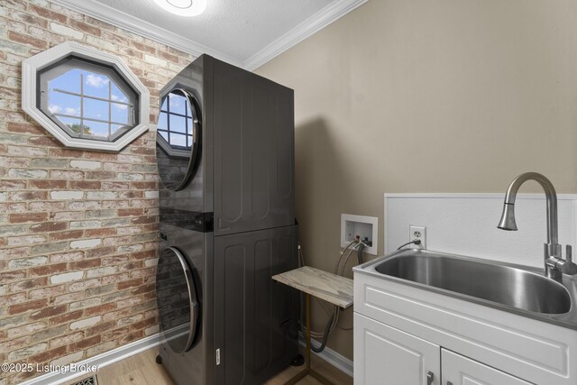 3205 Lake Pointe Ct, Crestwood, KY 40014 - washroom with stacked washer and clothes dryer, crown molding, cabinet space, wood finished floors, and baseboards
