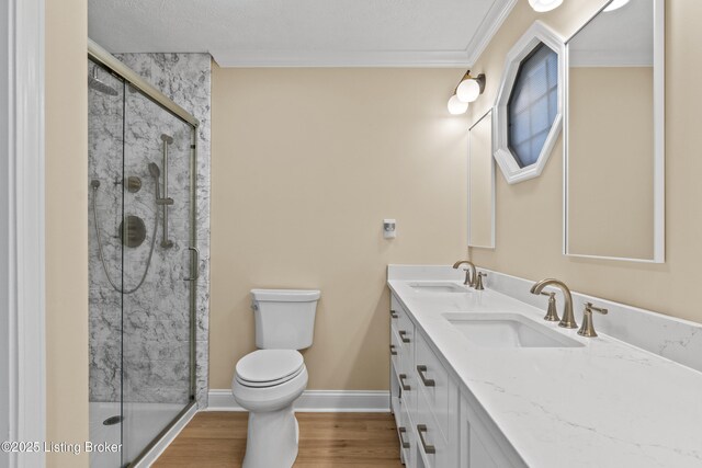 3205 Lake Pointe Ct, Crestwood, KY 40014 - bathroom featuring double vanity, toilet, a shower stall, wood finished floors, and ornamental molding