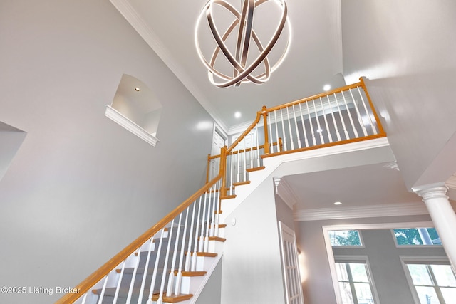 15108 Chestnut Ridge Cir, Louisville, KY 40245 - staircase with a towering ceiling, crown molding, recessed lighting, a chandelier, and decorative columns