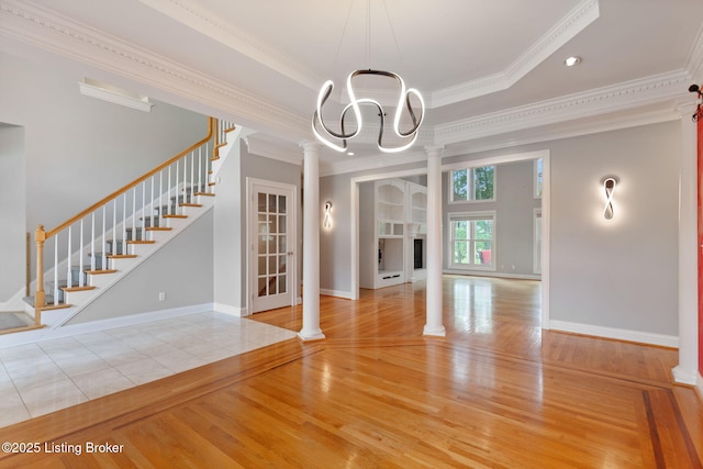 15108 Chestnut Ridge Cir, Louisville, KY 40245 - unfurnished dining area featuring wood finished floors, stairway, ornamental molding, a chandelier, and decorative columns