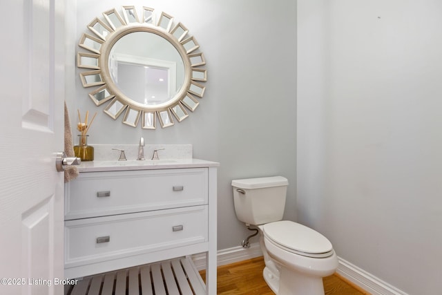 15108 Chestnut Ridge Cir, Louisville, KY 40245 - half bathroom with baseboards, toilet, vanity, and wood finished floors