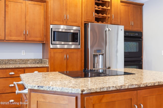 15108 Chestnut Ridge Cir, Louisville, KY 40245 - kitchen featuring black appliances, brown cabinets, and light stone countertops