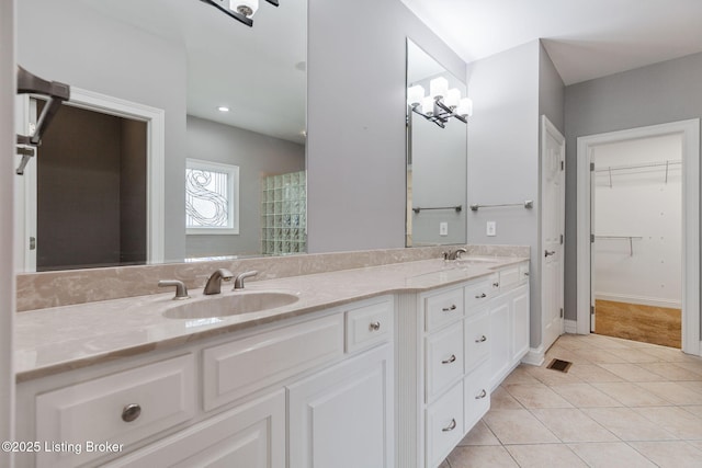 15108 Chestnut Ridge Cir, Louisville, KY 40245 - bathroom with double vanity, tile patterned flooring, a spacious closet, and baseboards