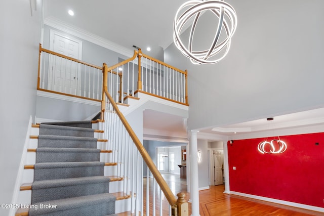 15108 Chestnut Ridge Cir, Louisville, KY 40245 - staircase featuring wood finished floors, crown molding, baseboards, decorative columns, and a chandelier