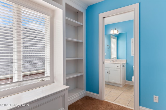15108 Chestnut Ridge Cir, Louisville, KY 40245 - hallway featuring built in shelves, plenty of natural light, and baseboards