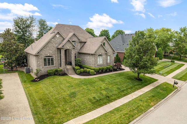 15108 Chestnut Ridge Cir, Louisville, KY 40245 - french country home with central AC, brick siding, a front lawn, and a shingled roof