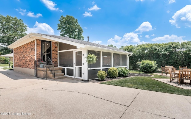 922 Fenley Ave, Louisville, KY 40222 - rear view of property with a sunroom, brick siding, a yard, and a patio area
