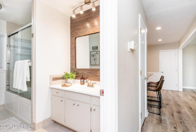 922 Fenley Ave, Louisville, KY 40222 - full bathroom with vanity, combined bath / shower with glass door, wood finished floors, and recessed lighting