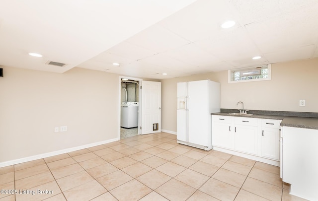 922 Fenley Ave, Louisville, KY 40222 - kitchen featuring white fridge with ice dispenser, washer / dryer, a sink, dark countertops, and recessed lighting