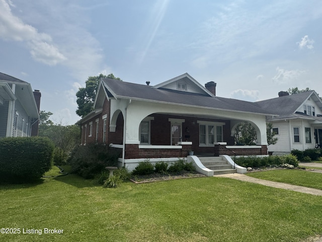 816 Highland Ave, Carrollton, KY 41008 - view of front of house featuring brick siding, a front lawn, covered porch, and a chimney