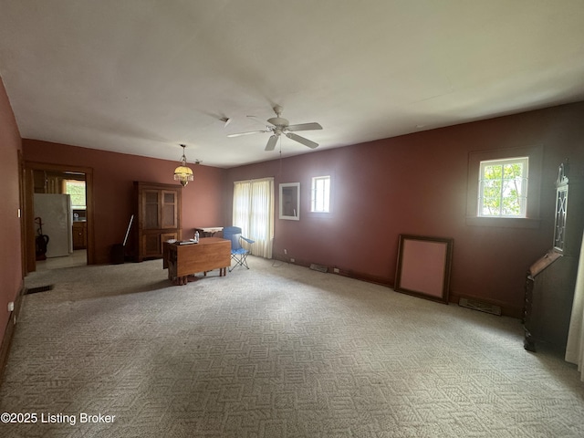 816 Highland Ave, Carrollton, KY 41008 - unfurnished living room featuring healthy amount of natural light, a ceiling fan, light carpet, and baseboards