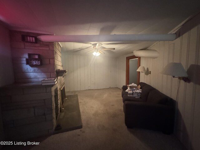 816 Highland Ave, Carrollton, KY 41008 - carpeted living area featuring a ceiling fan, wood walls, and a large fireplace