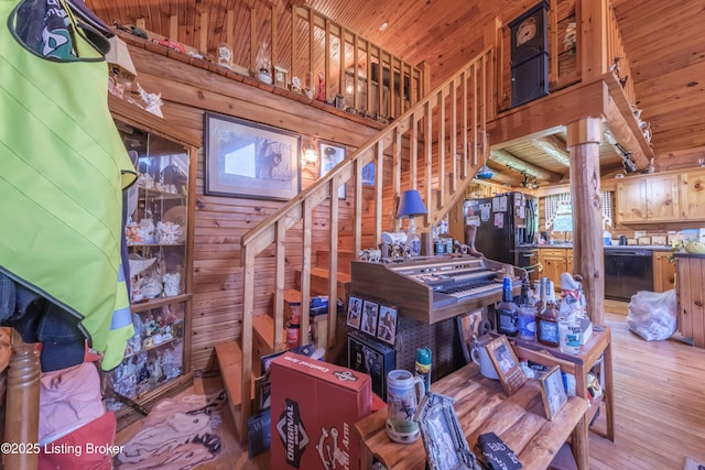 905 Camp Greenshores Rd, Mcdaniels, KY 40152 - stairs featuring wood ceiling, hardwood / wood-style flooring, wood walls, and a towering ceiling