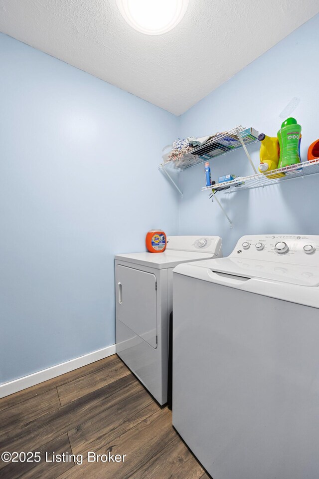 10608 Charlene Dr, Fairdale, KY 40118 - laundry area featuring separate washer and dryer, dark wood finished floors, and baseboards