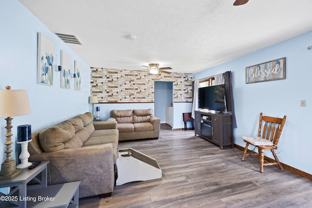 10608 Charlene Dr, Fairdale, KY 40118 - living room with ceiling fan, a textured ceiling, wood finished floors, and baseboards