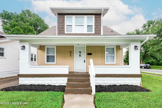 825 S 42nd St, Louisville, KY 40211 - view of front of property with covered porch, brick siding, and roof with shingles