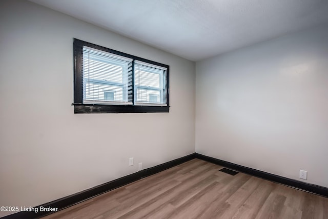 825 S 42nd St, Louisville, KY 40211 - spare room featuring wood finished floors and baseboards