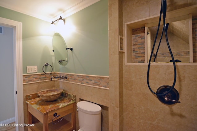 8201 Damascus Rd, Louisville, KY 40228 - full bath with a tile shower, tile walls, toilet, vanity, and a wainscoted wall