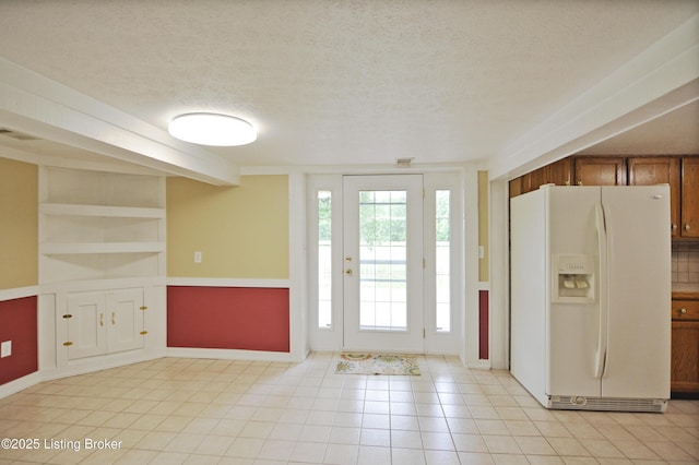8201 Damascus Rd, Louisville, KY 40228 - foyer with a textured ceiling, light tile patterned floors, and baseboards