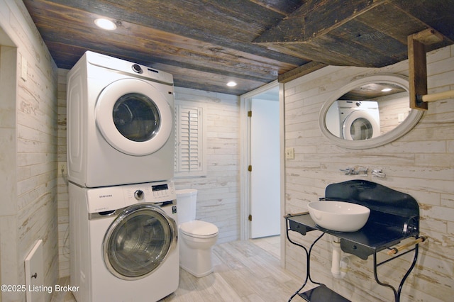 8201 Damascus Rd, Louisville, KY 40228 - washroom with stacked washing machine and dryer, wood walls, wood finished floors, wood ceiling, and recessed lighting