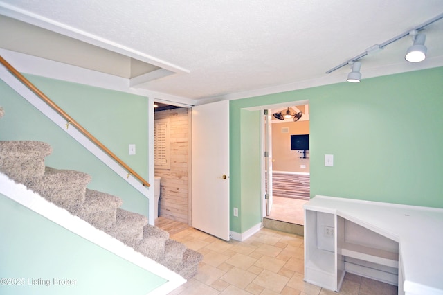 8201 Damascus Rd, Louisville, KY 40228 - interior space with light stone finish floors, baseboards, a textured ceiling, and rail lighting