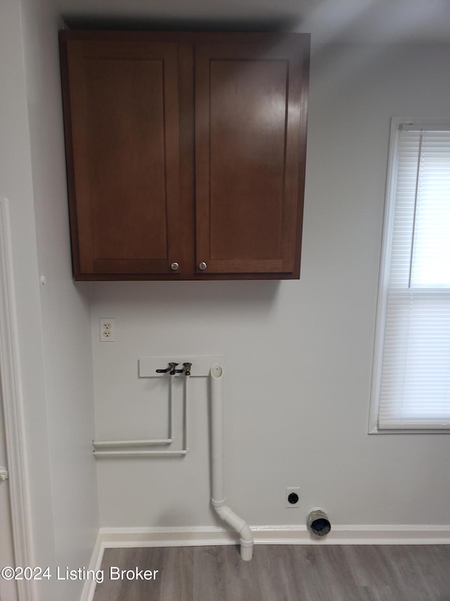 1020 Stanley Ave, Louisville, KY 40215 - washroom featuring washer hookup, electric dryer hookup, wood finished floors, baseboards, and cabinet space