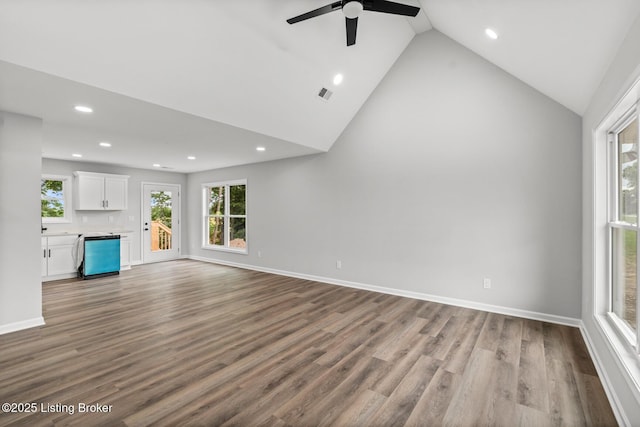 5482 Bagdad Rd, Bagdad, KY 40003 - unfurnished living room with recessed lighting, a ceiling fan, dark wood-style floors, high vaulted ceiling, and baseboards