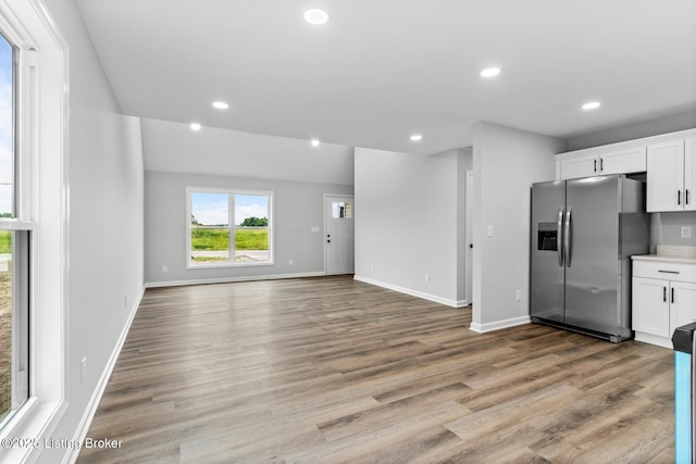 5482 Bagdad Rd, Bagdad, KY 40003 - kitchen featuring stainless steel fridge with ice dispenser, white cabinetry, light wood-style floors, baseboards, and recessed lighting