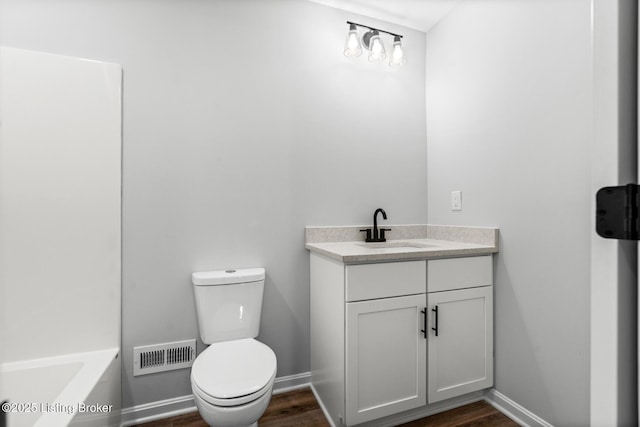 5482 Bagdad Rd, Bagdad, KY 40003 - full bath featuring toilet, vanity, wood finished floors, a bathtub, and baseboards