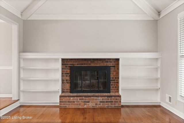 12409 Ledges Dr, Louisville, KY 40243 - detailed view of beam ceiling, wood finished floors, a brick fireplace, baseboards, and ornamental molding