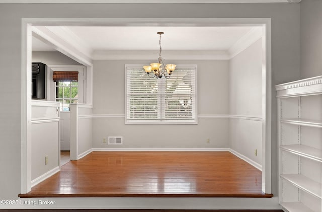 12409 Ledges Dr, Louisville, KY 40243 - unfurnished dining area with wood finished floors, a chandelier, crown molding, and baseboards