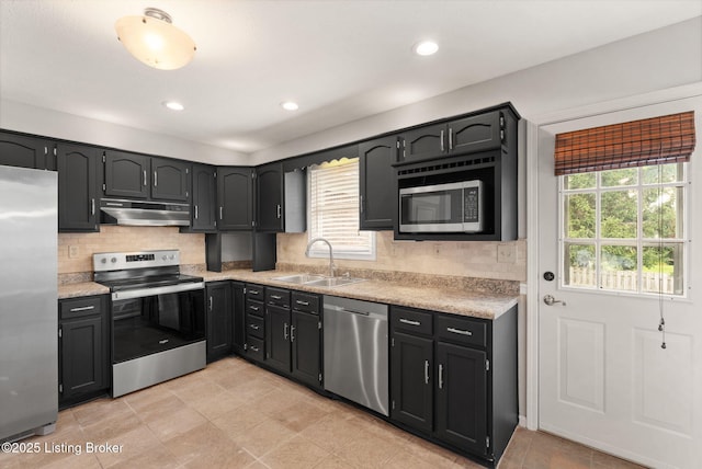 12409 Ledges Dr, Louisville, KY 40243 - kitchen featuring appliances with stainless steel finishes, a sink, under cabinet range hood, light countertops, and backsplash