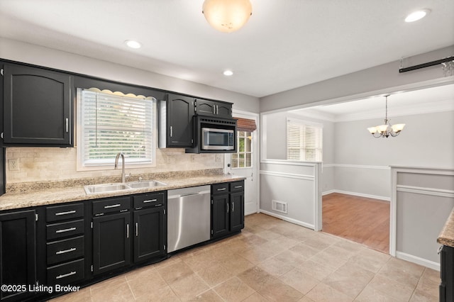 12409 Ledges Dr, Louisville, KY 40243 - kitchen featuring appliances with stainless steel finishes, a sink, dark cabinets, a chandelier, and crown molding
