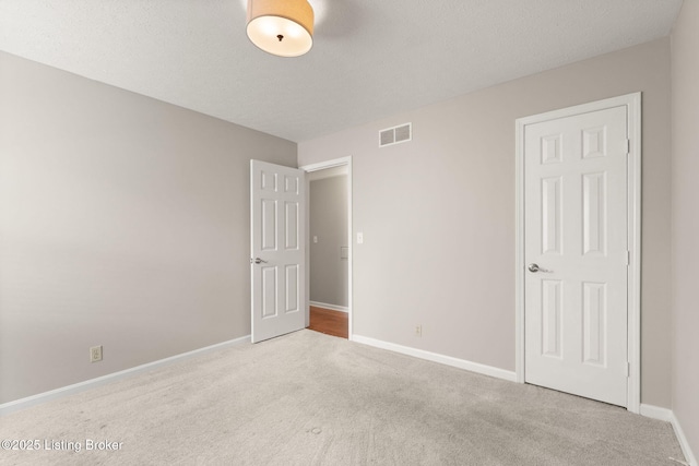 12409 Ledges Dr, Louisville, KY 40243 - unfurnished bedroom featuring carpet flooring, baseboards, and a textured ceiling