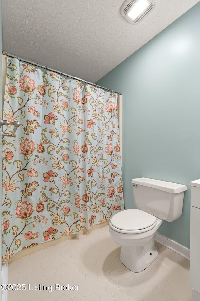 12409 Ledges Dr, Louisville, KY 40243 - full bath featuring toilet, tile patterned floors, vanity, a textured ceiling, and a shower with shower curtain