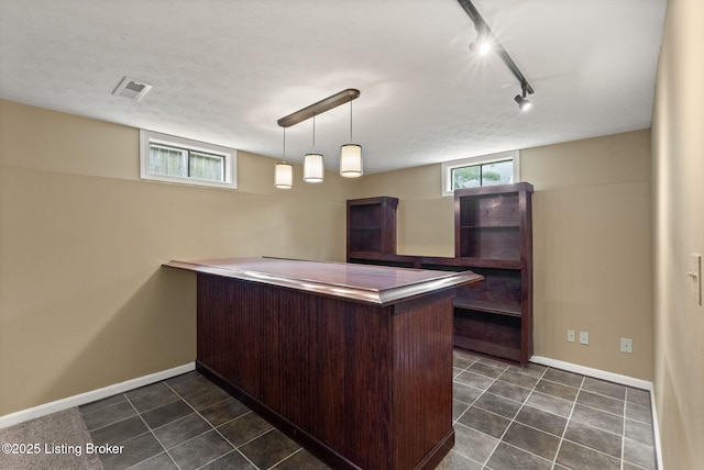 12409 Ledges Dr, Louisville, KY 40243 - indoor dry bar featuring rail lighting, baseboards, dark tile patterned flooring, and decorative light fixtures