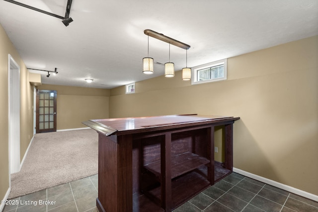 12409 Ledges Dr, Louisville, KY 40243 - bar with track lighting, baseboards, dark colored carpet, and dark tile patterned floors