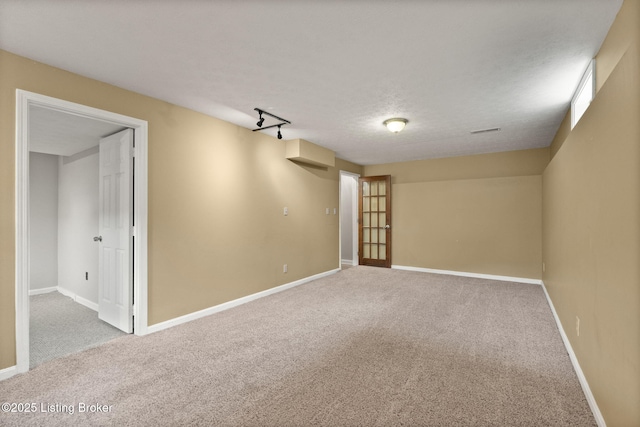12409 Ledges Dr, Louisville, KY 40243 - spare room featuring carpet floors, rail lighting, and baseboards