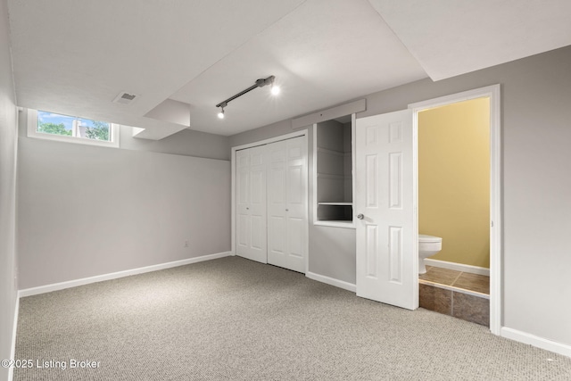 12409 Ledges Dr, Louisville, KY 40243 - unfurnished bedroom featuring carpet floors, a closet, baseboards, and track lighting