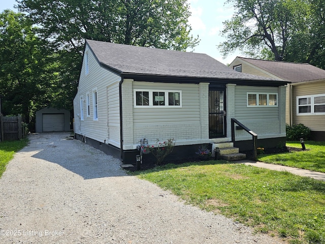 1165 Lincoln Ave, Louisville, KY 40208 - view of front of property featuring driveway, entry steps, an outbuilding, a detached garage, and a shingled roof