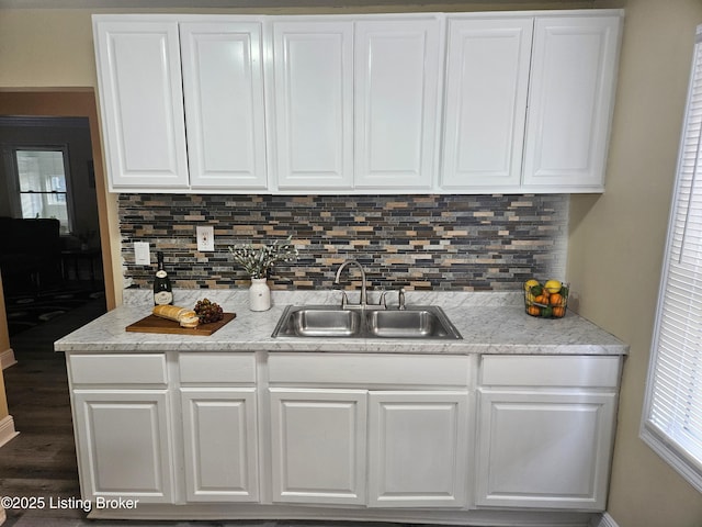 1165 Lincoln Ave, Louisville, KY 40208 - kitchen featuring a sink, white cabinets, and tasteful backsplash