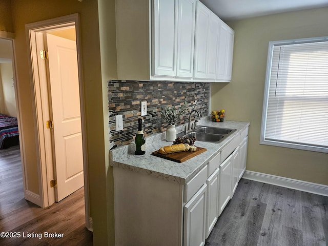 1165 Lincoln Ave, Louisville, KY 40208 - kitchen with a sink, wood finished floors, tasteful backsplash, and white cabinetry